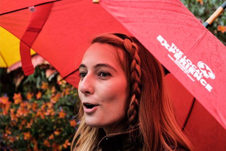 a person holding a colorful umbrella